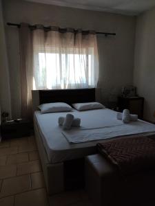 a bedroom with a large bed with a window at Aquarius Hotel in Fourka