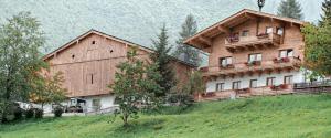 a large wooden building on top of a hill at Unterholzhof in Piesendorf