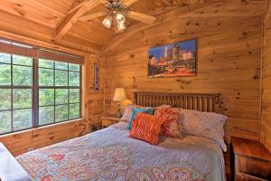 a bedroom with a bed in a wooden cabin at Quaint Log Cabin with Views Near West Jefferson in Warrensville