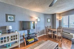 a living room with a dining room table and a television at 10th-Floor Condo on Myrtle Beach with Pools! in Myrtle Beach