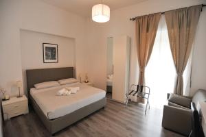 Кровать или кровати в номере Le Fontane di Roma