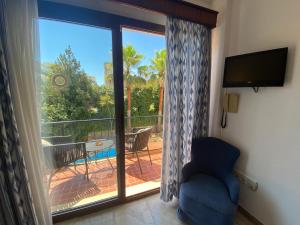 a room with a sliding glass door with a view of a patio at Hs Villa Rosa Paguera in Paguera