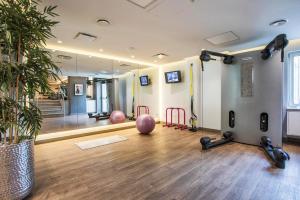 a gym with exercise balls and a large mirror at Crowne Plaza Limassol by IHG in Limassol