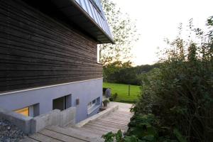 a house with a staircase next to a building at Modern & Friendly Apartment Ammersee in Windach
