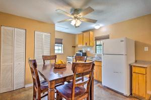 eine Küche mit einem Tisch und einem weißen Kühlschrank in der Unterkunft Texas Cabin on 130 Acres Walk to Lake Ray Roberts in Collinsville