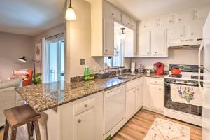 a kitchen with white cabinets and a counter top at Tiny Home Retreat with Patio, Walk to 6th St in Austin