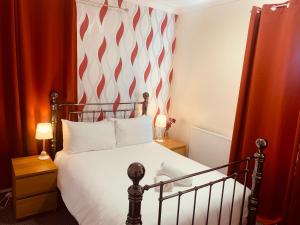 a bed with a white bedspread and pillows in a bedroom at Preston Hotel in Yeovil