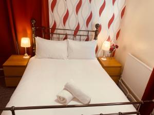 a hotel room with a bed with a towel on it at The Preston in Yeovil