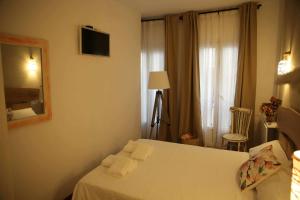 a hotel room with a bed with towels on it at Apartamento ichigoichie in Lekeitio