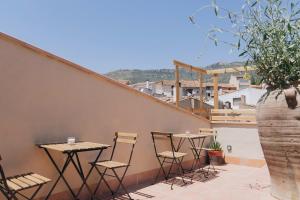 a patio with tables and chairs on a wall at Apartaments la Rambla - Arbequina - 6 persones in Cornudella