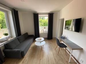 a living room with a couch and a table at Apartmány LUXOR in Česká Lípa