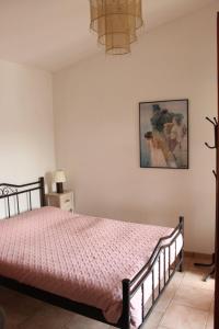 a bedroom with a bed with a pink comforter at Rocka View in Meganisi +25 photos