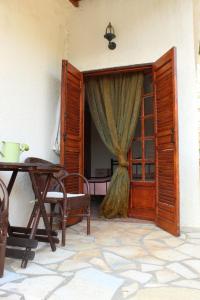 an open door to a room with a table and a window at Rocka View in Meganisi