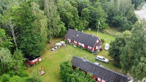 an aerial view of a red house with a group of people in a yard at Swedish Idyll in Årstad