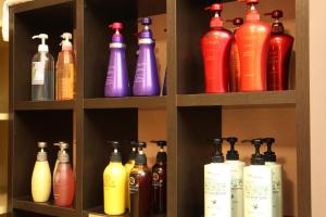 a shelf filled with lots of different colored bottles at Hotel Naturwald Furano in Furano