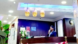 a woman talking on a cell phone in a salon at Safari Hotel Apartments in Ajman 