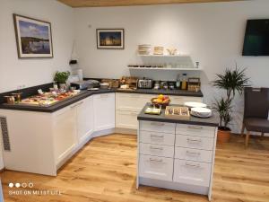a kitchen with a counter with food on it at Gästehaus Kuck in Monschau