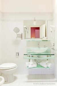 a white bathroom with a sink and a toilet at Villa Pirandello in Rome