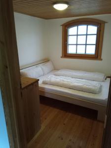 Duas camas num quarto com uma janela em Ferienhaus Kranichhorst - Exklusiv-Nutzung mit großem Garten und Strandnähe em Bodstedt