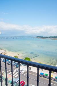 a view of the ocean from a balcony at O Grove Centro con vistas a La Toja parking in O Grove