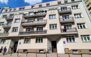 a large building with people walking in front of it at Apartamenty u Portera w Centrum in Gdynia