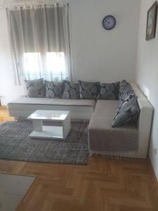 a living room with a couch and a coffee table at Apartment Adam-Zlatiborska Vila I in Zlatibor