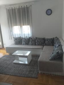a living room with a couch and a coffee table at Apartment Adam-Zlatiborska Vila I in Zlatibor