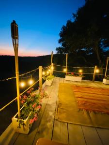a patio with lights and flowers on a deck at Villa Edera in San Venanzo