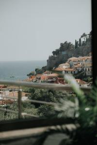 a view from a window of a town and the ocean at elia boutique hotel in Parga