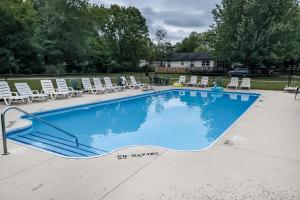 a large swimming pool with lounge chairs and a pool at Beach House in Saugatuck