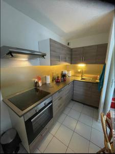 a kitchen with a sink and a stove at Charming Apt With Balcony In La Plagne Montalbert in La Plagne