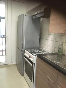 een keuken met een roestvrijstalen koelkast en een fornuis bij Residentie Jan Bart in Oostende