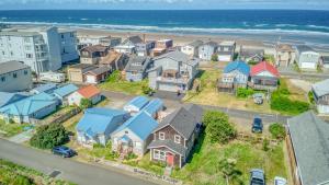 an aerial view of a neighborhood with houses and the ocean at Alpine Coast Cottage - Meredith Lodging in Rockaway Beach