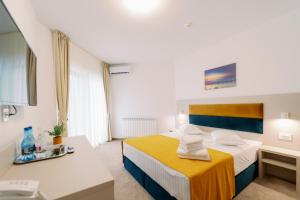 Postel nebo postele na pokoji v ubytování NOVUS Hotel
