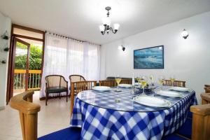 a dining room with a blue and white checkered table at Apartamento 3 Dormitorios a solo 1 calle del Mar ツ in Puerto de Gaira +19 photos