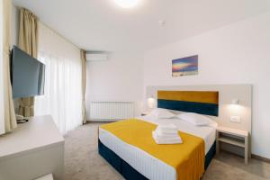 Postel nebo postele na pokoji v ubytování NOVUS Hotel