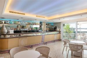 a bar in a restaurant with tables and chairs at Playas del Rey in Santa Ponsa