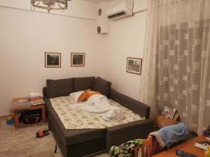 a bedroom with a bed with a stuffed animal on it at Entire Bedroom Apartment with big Balcony Perfect for Families Mishev in Nea Moudania
