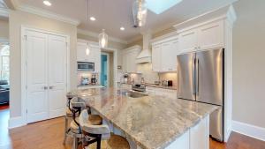 a kitchen with a large marble counter top and appliances at 5 Rum Row in Hilton Head Island
