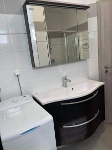 a bathroom with a sink and a mirror at Kuča za odmor BACHUS in Peroj