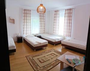 a living room with two beds and a table at DW Bukówka in Karpacz