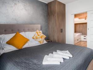 a bedroom with a bed with towels on it at Wellness Apartmány Panorama in Luhačovice