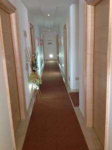 a corridor in a hotel with a long hallway at Hotel Corallo in Torre Santa Sabina