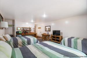 a hotel room with two beds and a desk at Backwoods Lodge in Cantwell