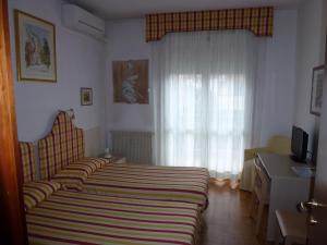 Ein Bett oder Betten in einem Zimmer der Unterkunft Affittacamere Locanda la Posta