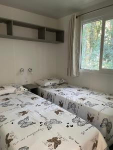 a bedroom with two beds with butterflies on them at Dolores ONLY 250 METERS TO THE BEACH in Banjole