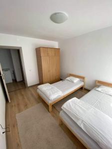 a bedroom with two beds and a cabinet at Mangalia Port in Mangalia +5 photos