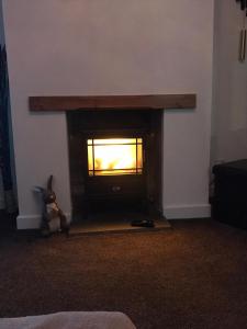 a fireplace in the corner of a living room at Four waves in Thurso
