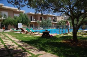 a man standing next to a swimming pool at Elea in Kato Daratso