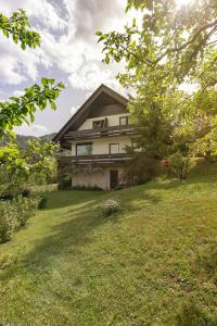 a house sitting on top of a lush green yard at ATMOSPHERE Apartments in Bled